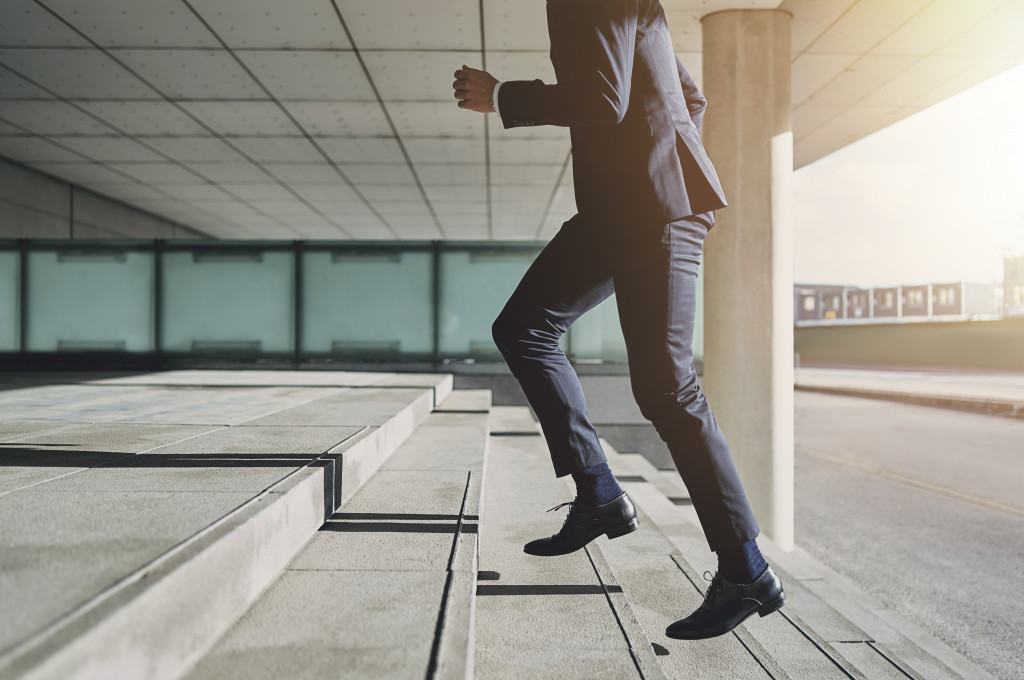 businessman climbing some stairs