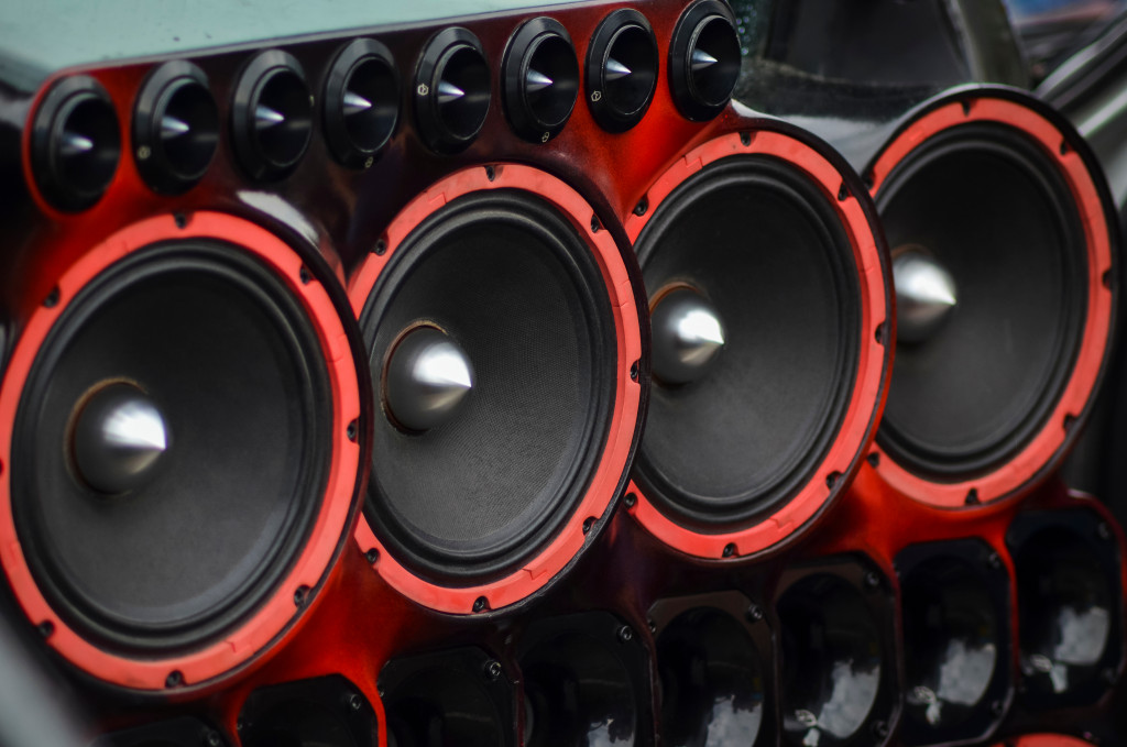 A close-up of big speakers, their cones clearly visible