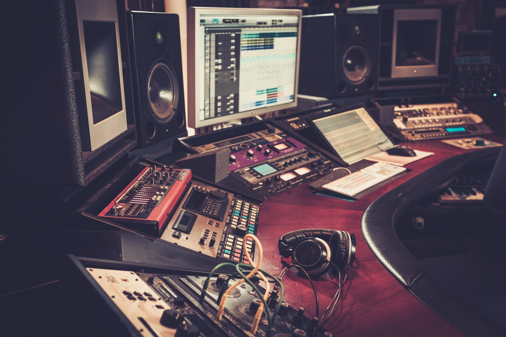 An image shows a part of the professional audiophile's setup including professional-grade speakers, headsets, and audio interface. 